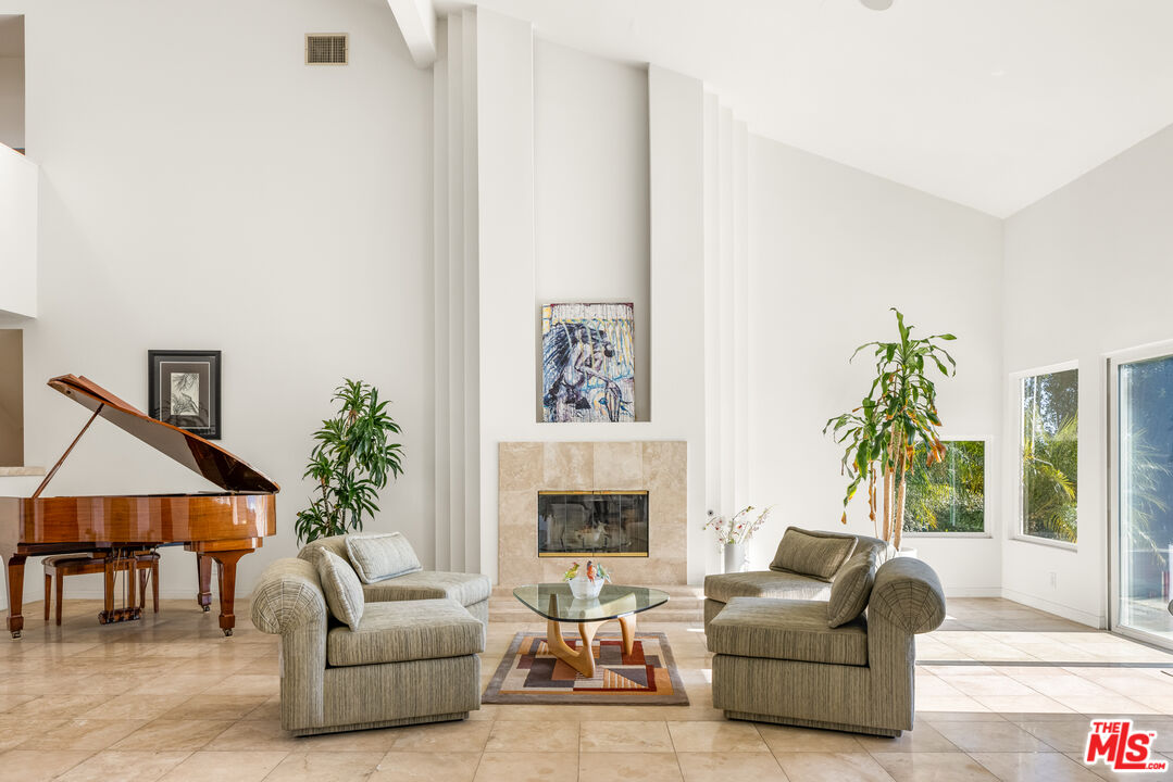 1641 Stradella Road Los Angeles, CA 90077 - Photo 8 of 23 a living room with furniture and a fireplace