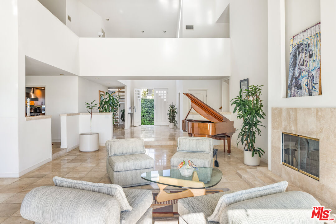 1641 Stradella Road Los Angeles, CA 90077 - Photo 9 of 23 a living room with furniture and a fireplace