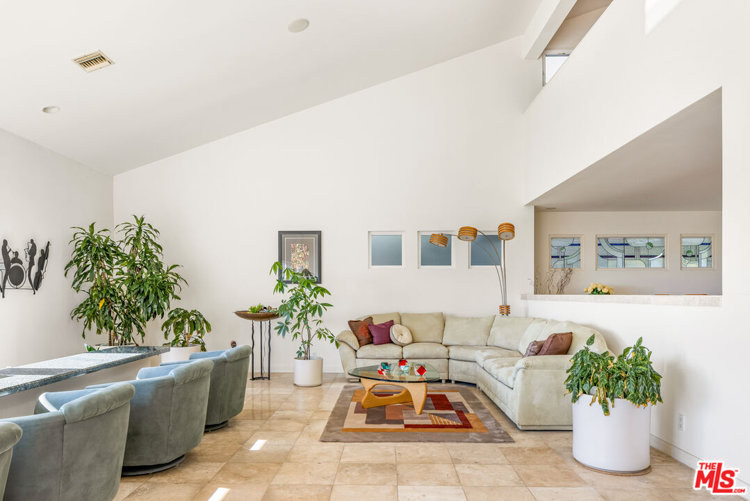 1641 Stradella Road Los Angeles, CA 90077 - Photo 10 of 23 a living room with furniture flowerpot and a potted plant
