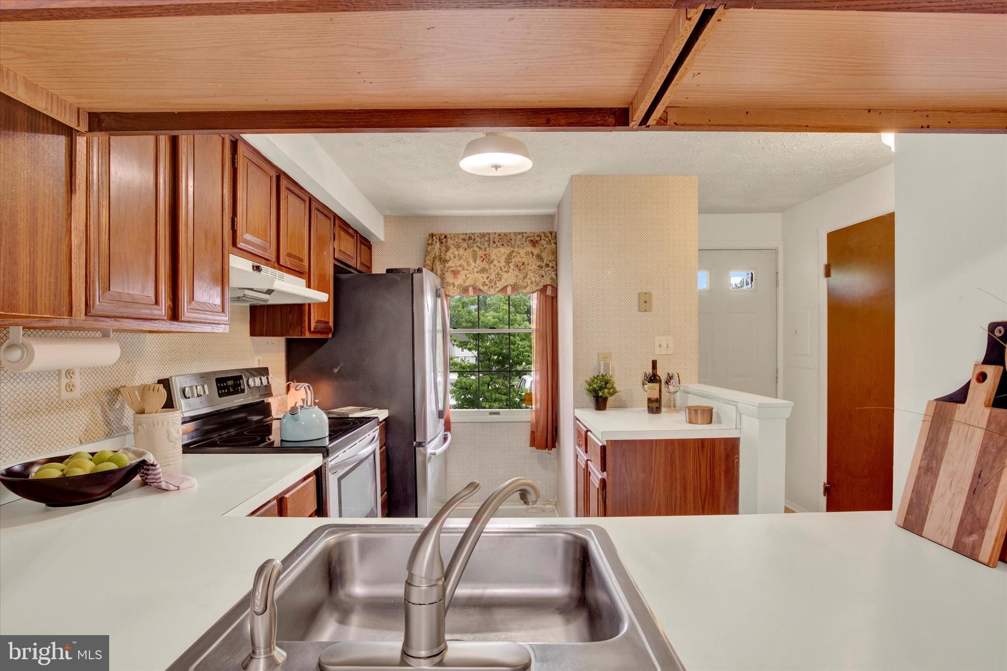 6 Stillwood Circle Nottingham, MD 21236 - Photo 5 of 21 a kitchen with stainless steel appliances a sink a stove a refrigerator a counter top space and cabinets