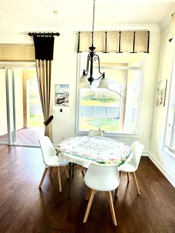 a view of a dining room with furniture and wooden floor