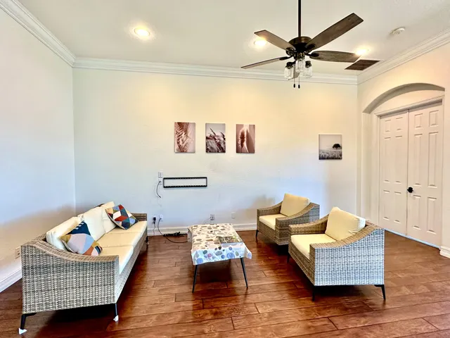 a living room with furniture and wooden floor