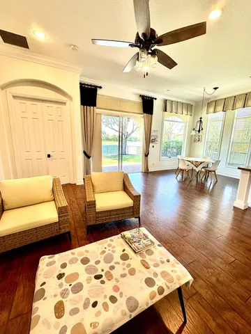 a living room with furniture and wooden floor