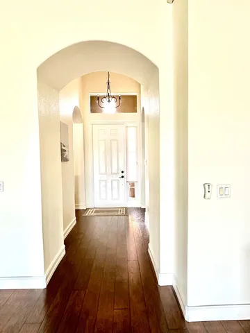 a view of a hallway with wooden floor