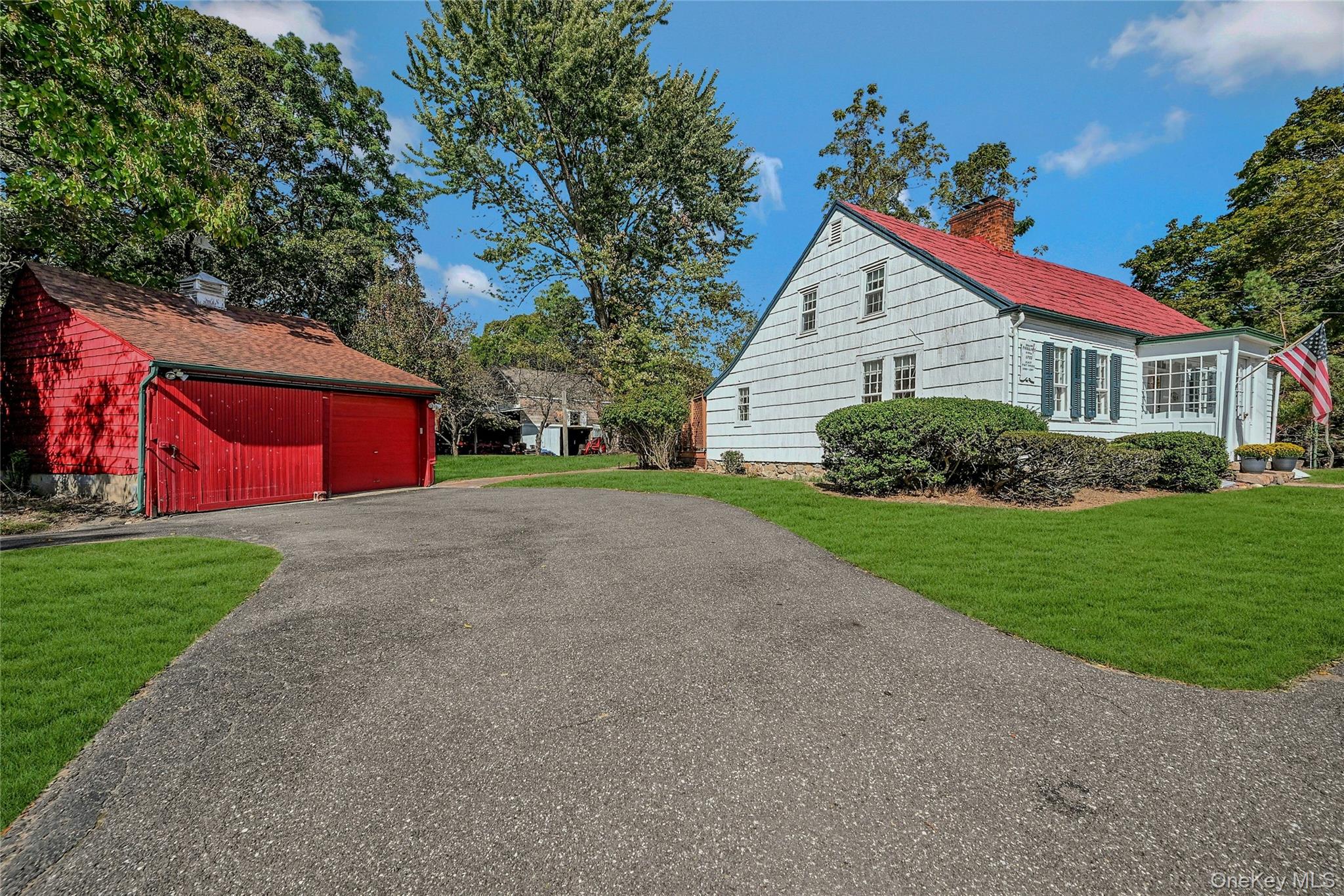 View of front of home with driveway and detached two car garage