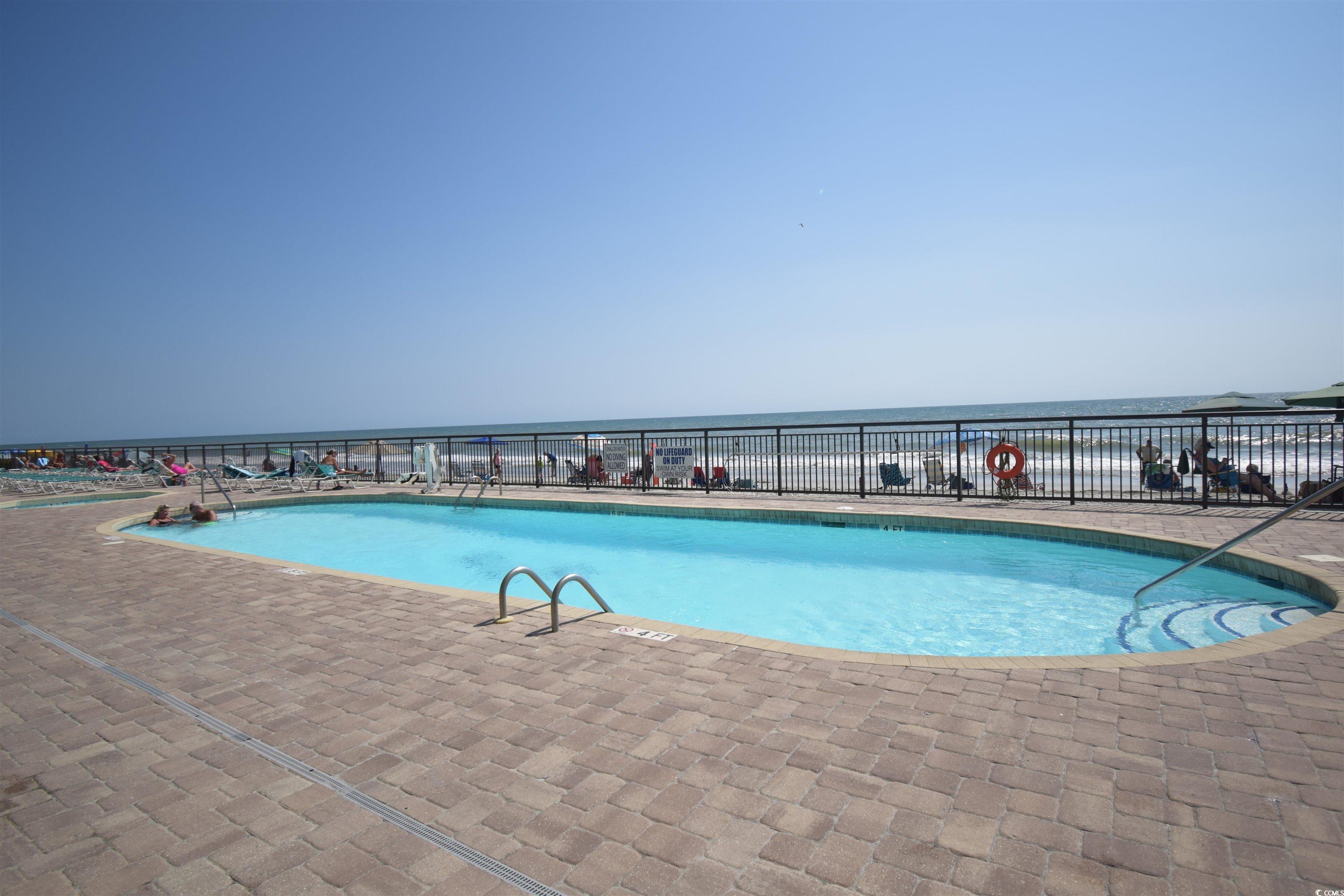 1210 North Waccamaw Drive, Unit 1102 Murrells Inlet, SC 29576 - Photo 31 of 40 Community pool featuring a water view and a patio
