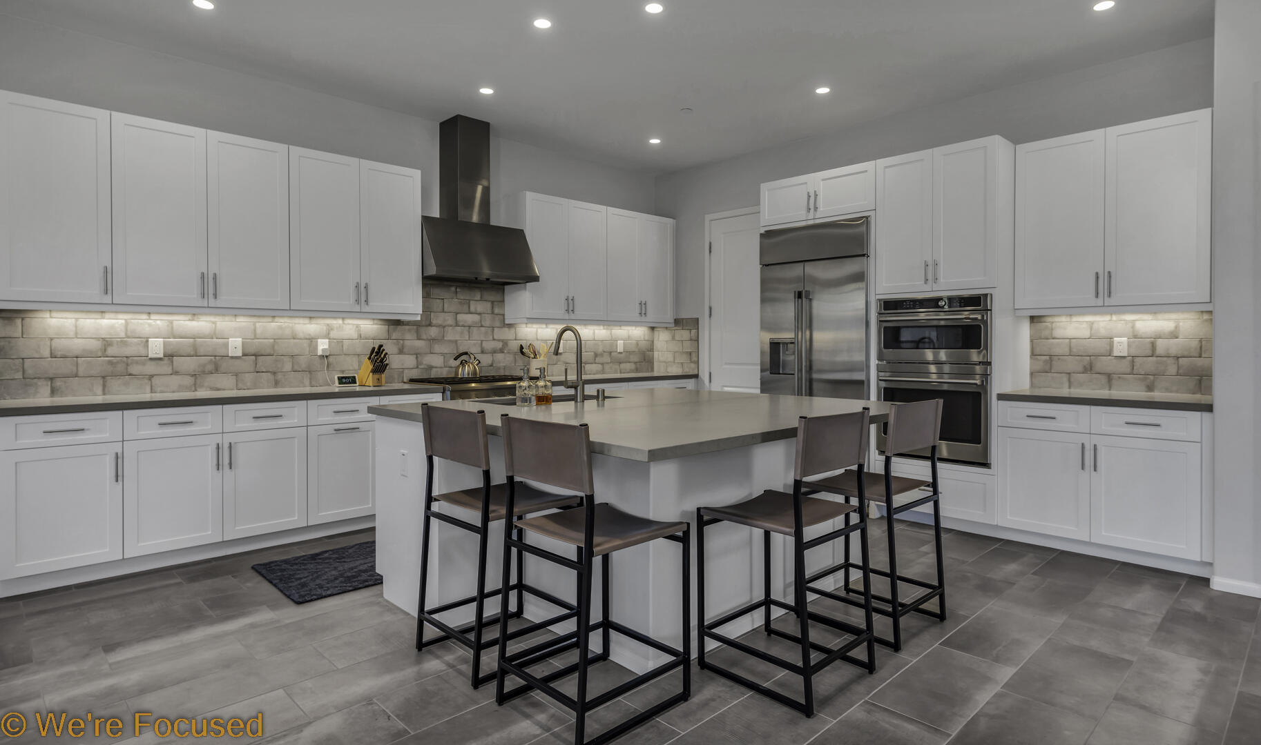 50845 Bee Canyon Drive Indio, CA 92201 - Photo 17 of 74 a kitchen with stainless steel appliances a dining table chairs sink and cabinets