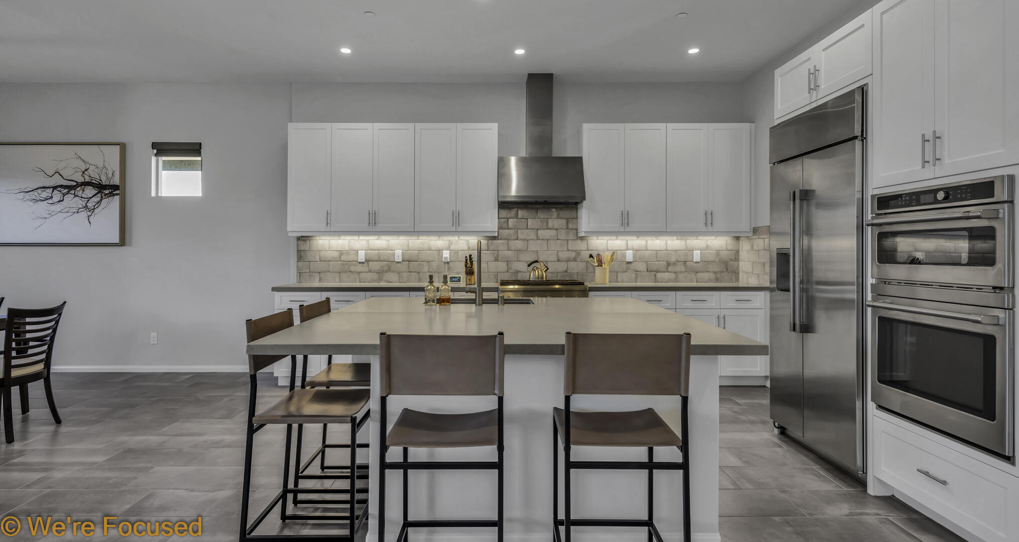 50845 Bee Canyon Drive Indio, CA 92201 - Photo 18 of 74 a kitchen with kitchen island white cabinets and stainless steel appliances