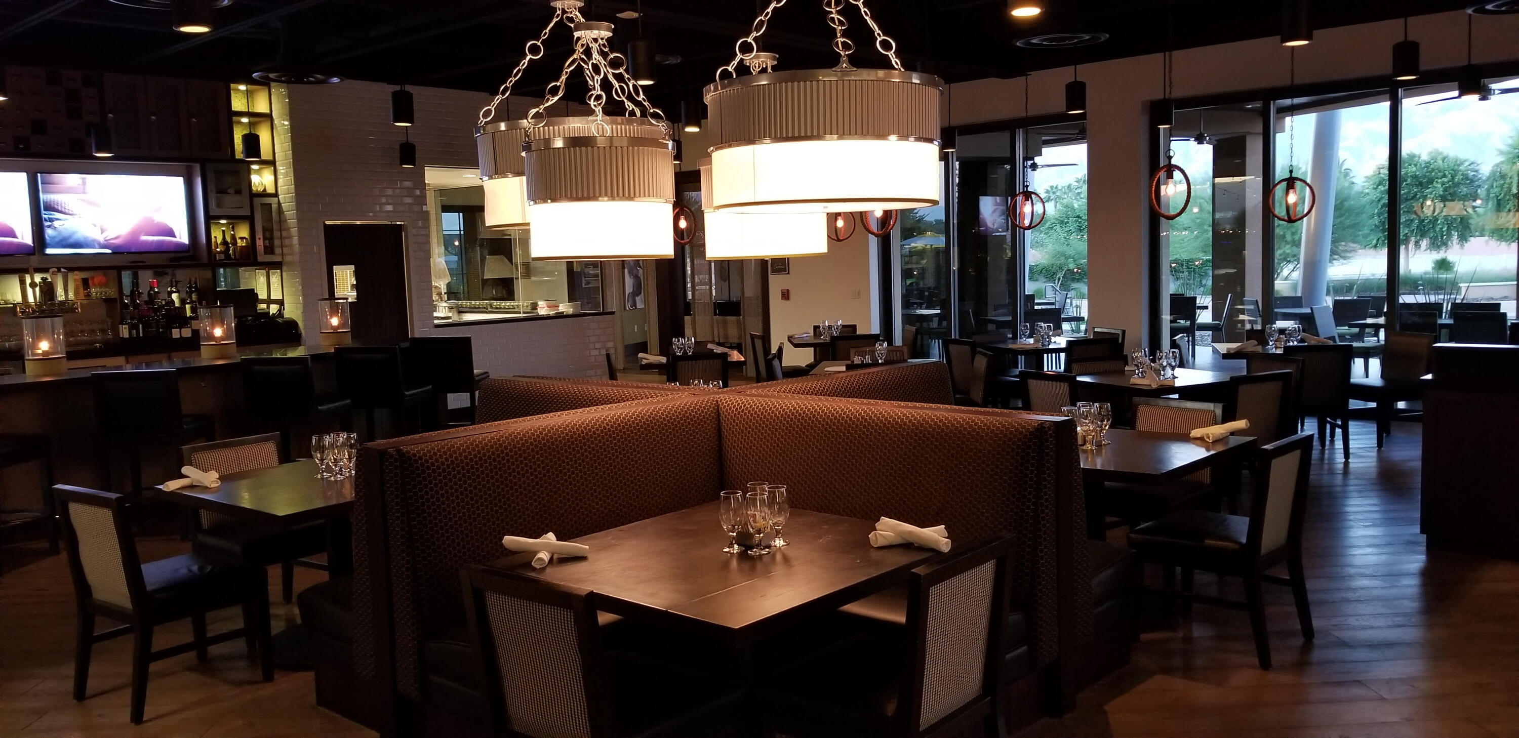 50845 Bee Canyon Drive Indio, CA 92201 - Photo 66 of 74 a living room with couches a coffee table and chairs with floor to ceiling window