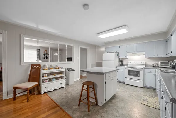 a kitchen with stainless steel appliances granite countertop a stove and cabinets