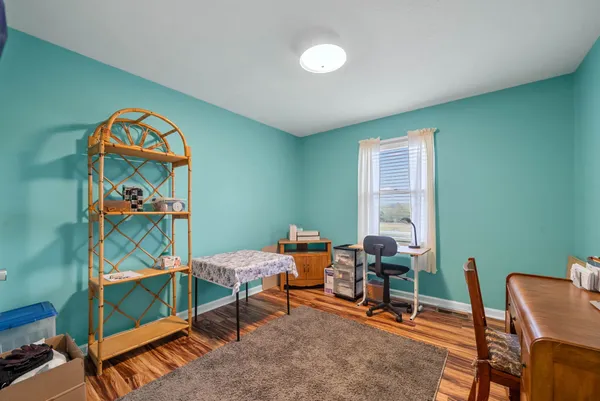 a bedroom with furniture and a window