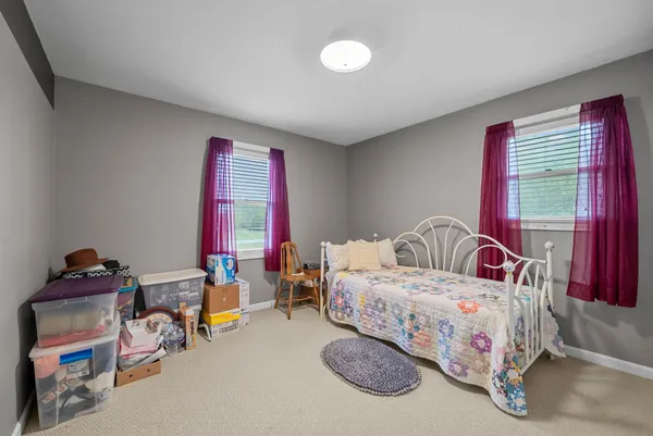 a bedroom with a bed and a dresser