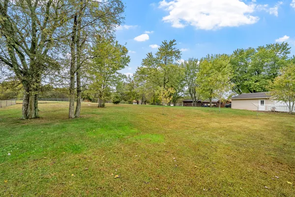 a front view of a house with a garden and yard