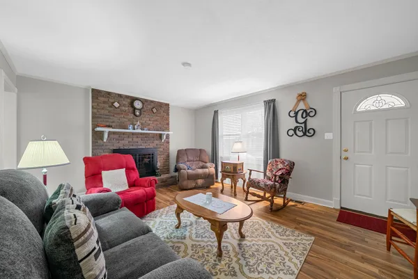 a living room with furniture and a lamp