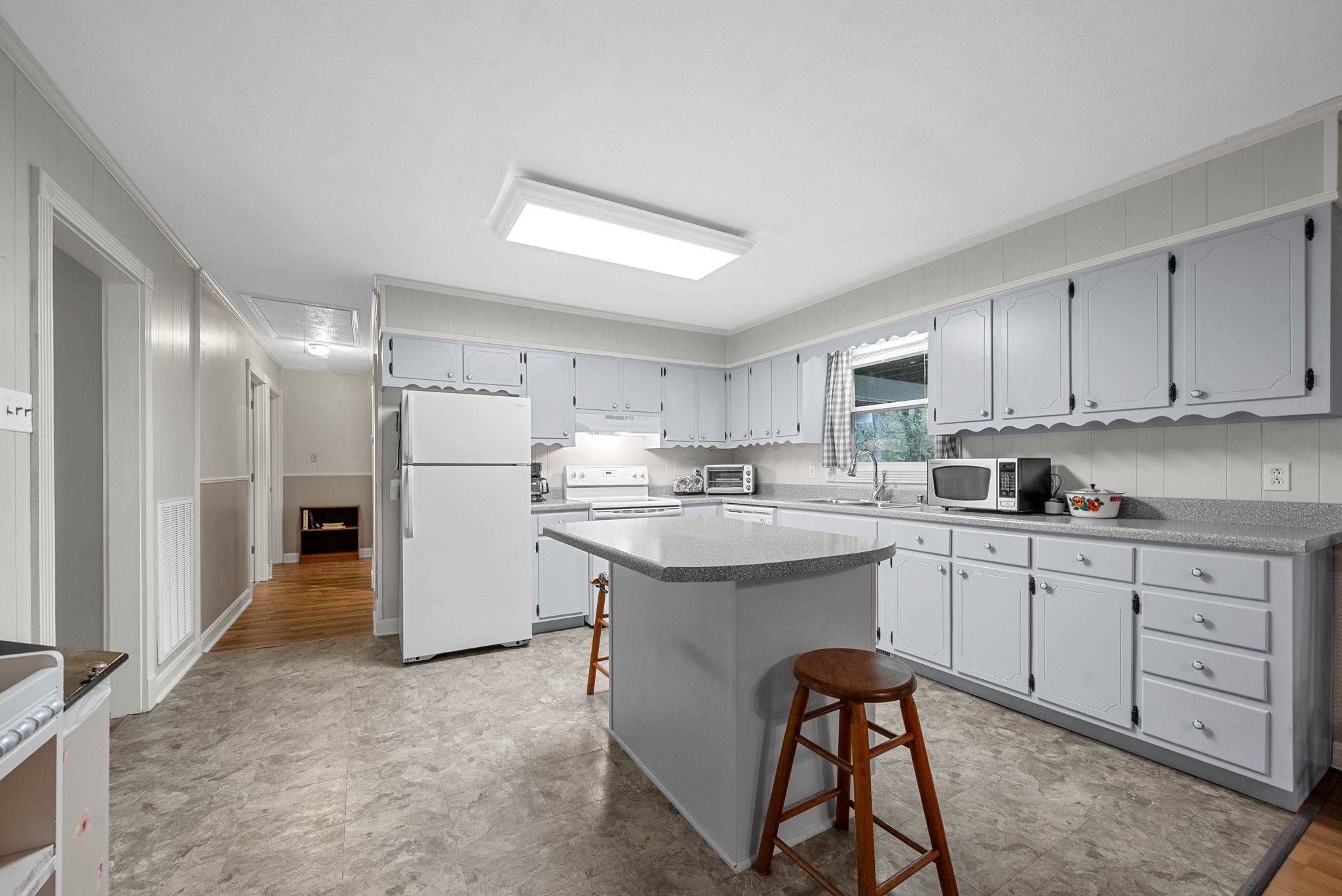 5675 Princeton Road Hopkinsville, KY 42240 - Photo 10 of 38 a kitchen with white cabinets and white appliances