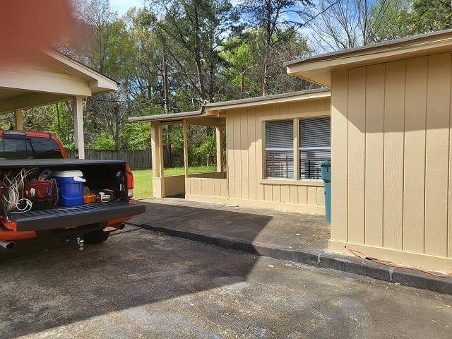 4985 Millbranch Road Memphis, TN 38116 - Photo 6 of 8 a backyard of a house with barbeque oven and outdoor seating