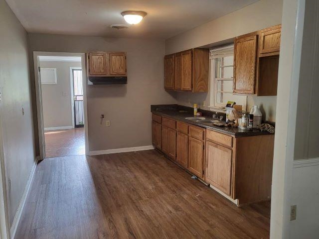4985 Millbranch Road Memphis, TN 38116 - Photo 8 of 8 a kitchen with stainless steel appliances granite countertop wooden cabinets a stove a sink and a wooden floor