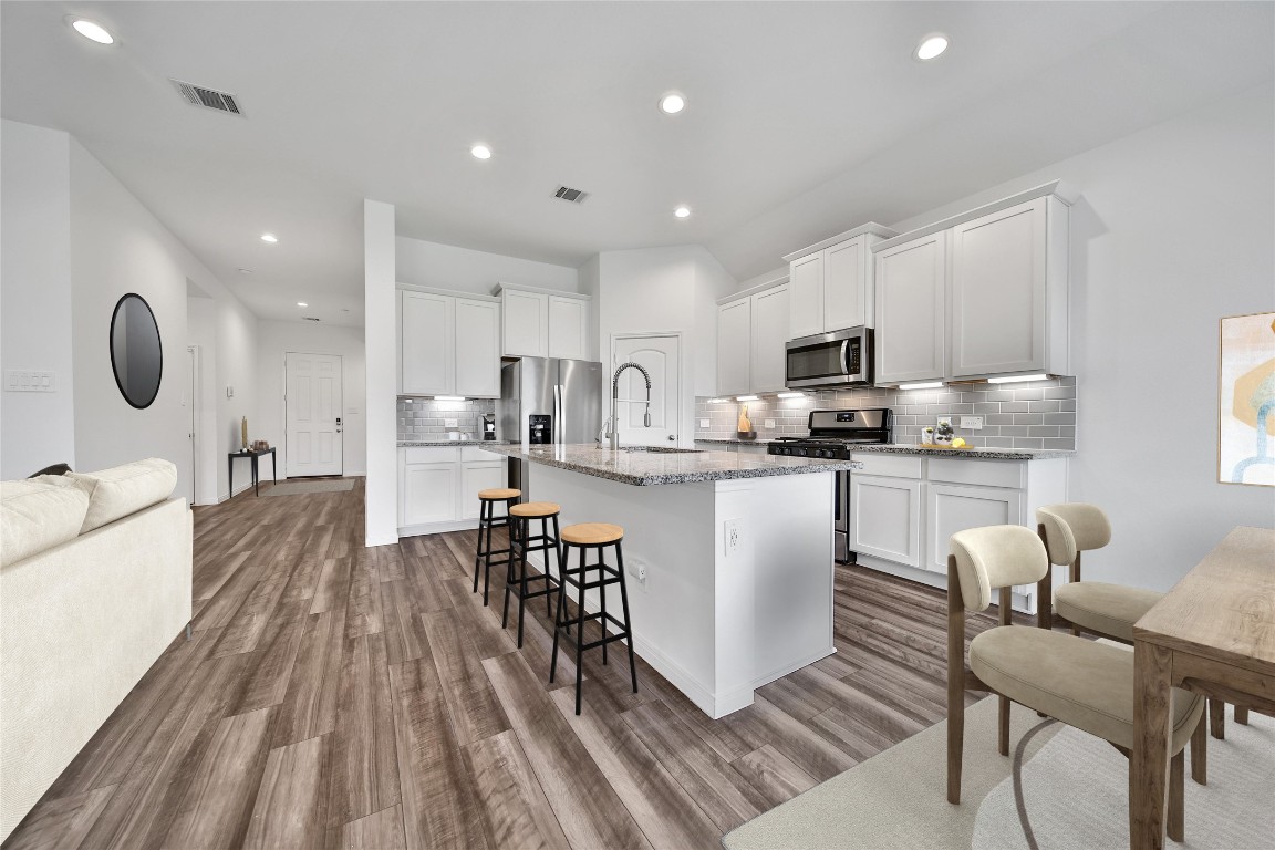 906 Youth Water Road Montgomery, TX 77316 - Photo 14 of 42 a kitchen with counter space appliances and a dining table