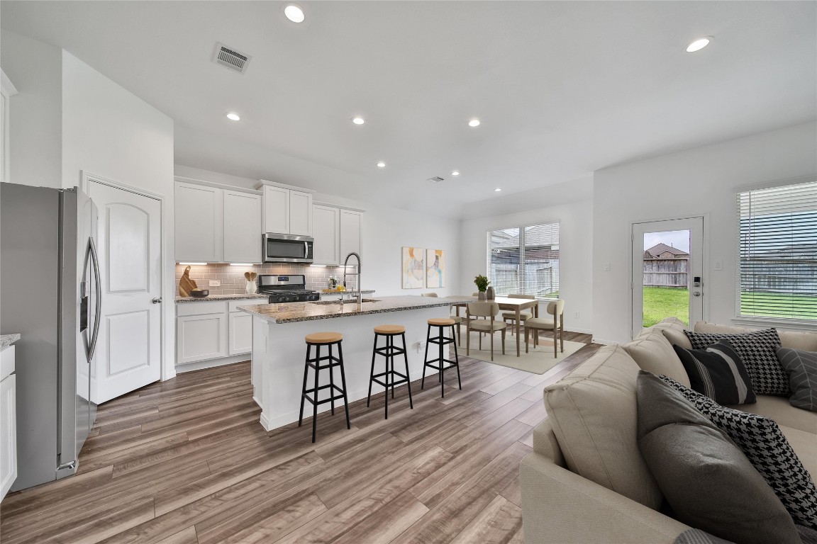 906 Youth Water Road Montgomery, TX 77316 - Photo 17 of 42 a open kitchen with white cabinets and stainless steel appliances