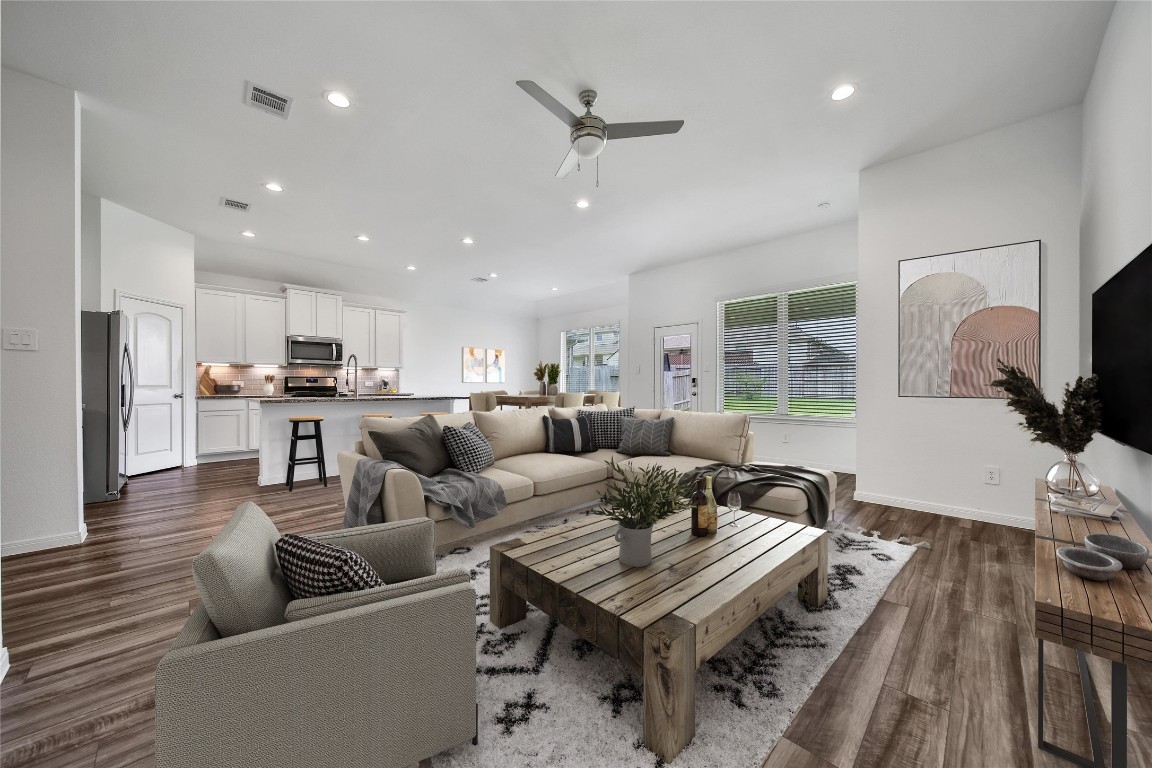 906 Youth Water Road Montgomery, TX 77316 - Photo 41 of 42 a living room with furniture kitchen view and a wooden floor