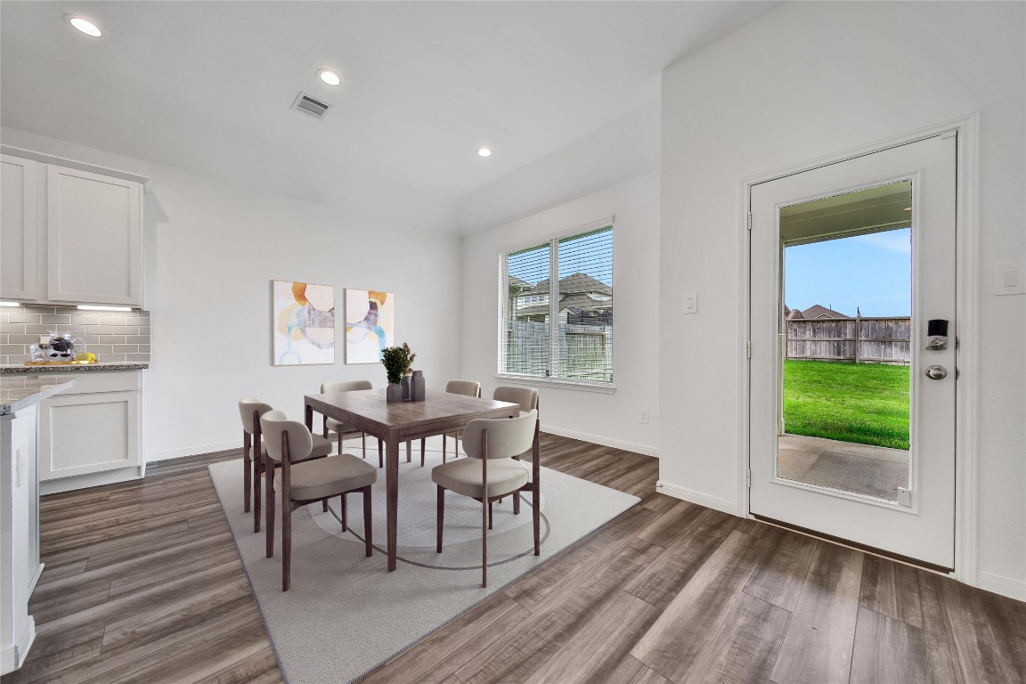 906 Youth Water Road Montgomery, TX 77316 - Photo 19 of 42 a view of a dining room with furniture and wooden floor