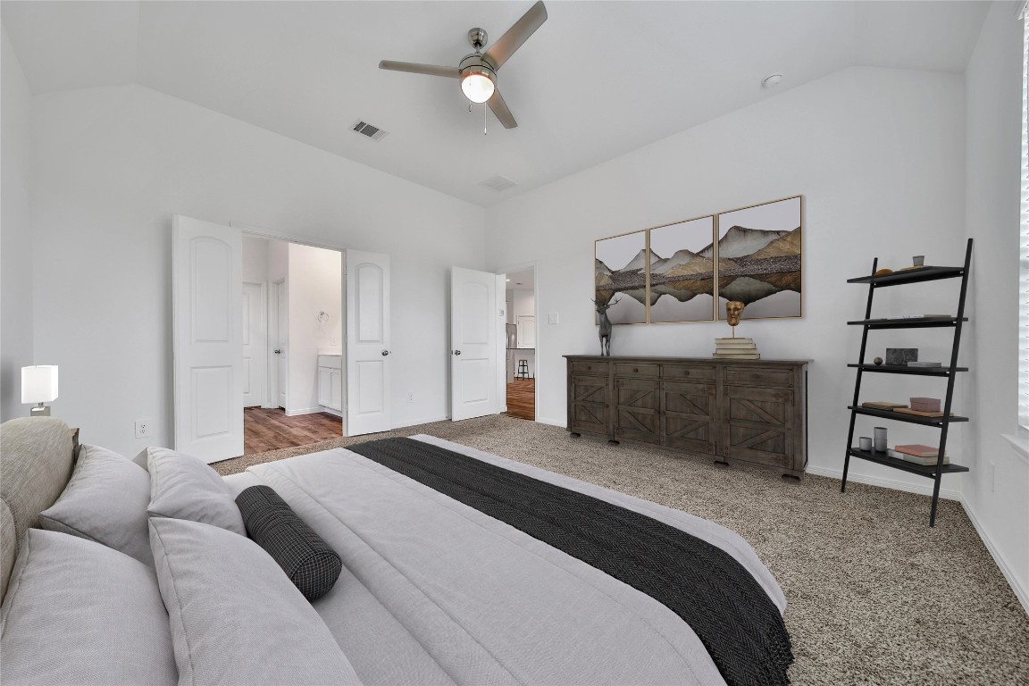 906 Youth Water Road Montgomery, TX 77316 - Photo 21 of 42 a bedroom with a bed a couch and dresser