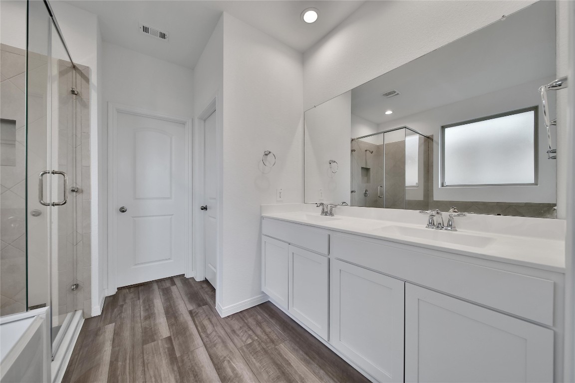 906 Youth Water Road Montgomery, TX 77316 - Photo 24 of 42 a bathroom with a double vanity sink and mirror