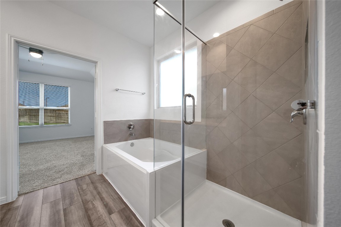 906 Youth Water Road Montgomery, TX 77316 - Photo 25 of 42 a bathroom with a tub a sink a window and a shower