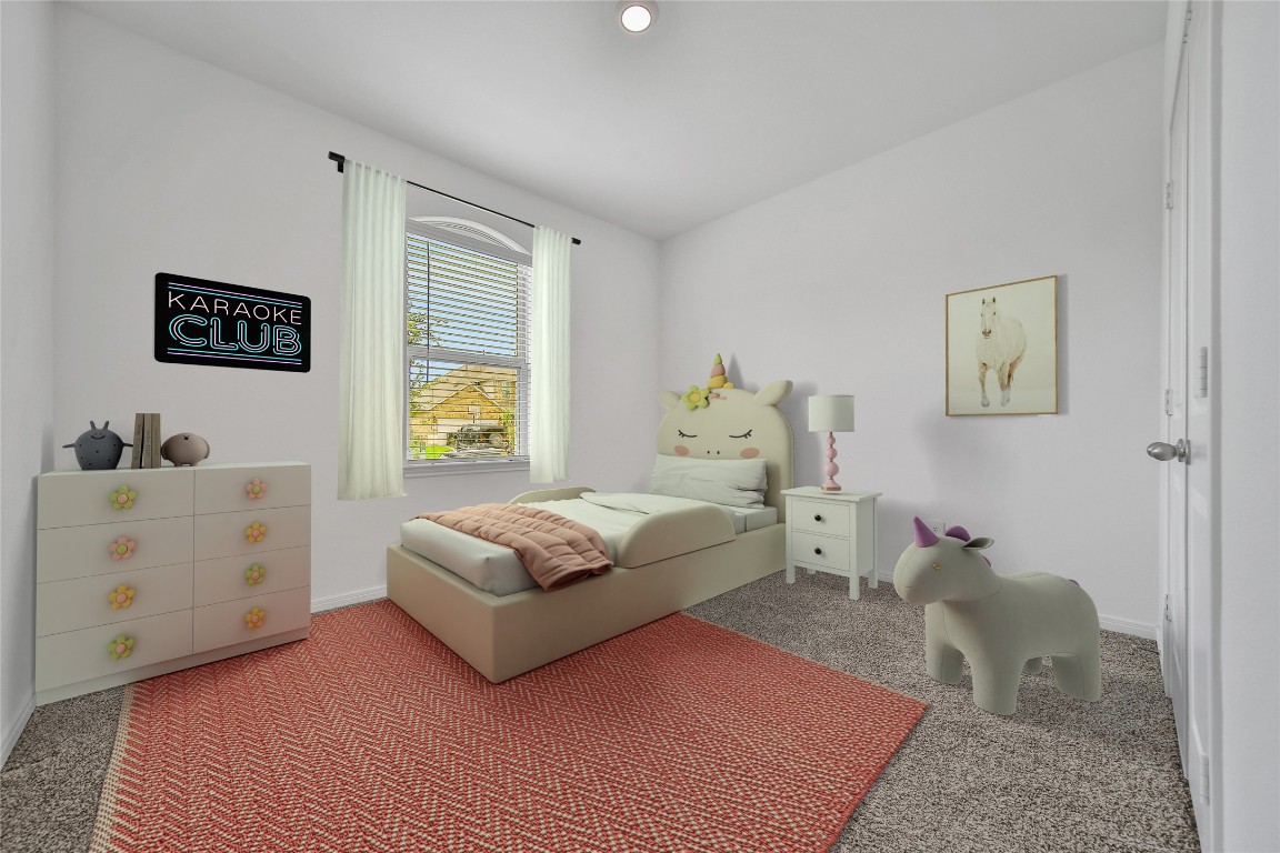 906 Youth Water Road Montgomery, TX 77316 - Photo 26 of 42 a spacious bedroom with a bed a couch and a window