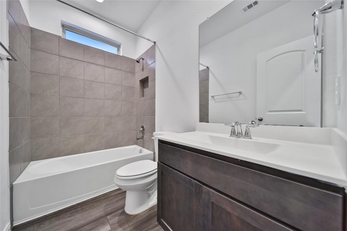 906 Youth Water Road Montgomery, TX 77316 - Photo 27 of 42 a bathroom with a sink a toilet and a large mirror