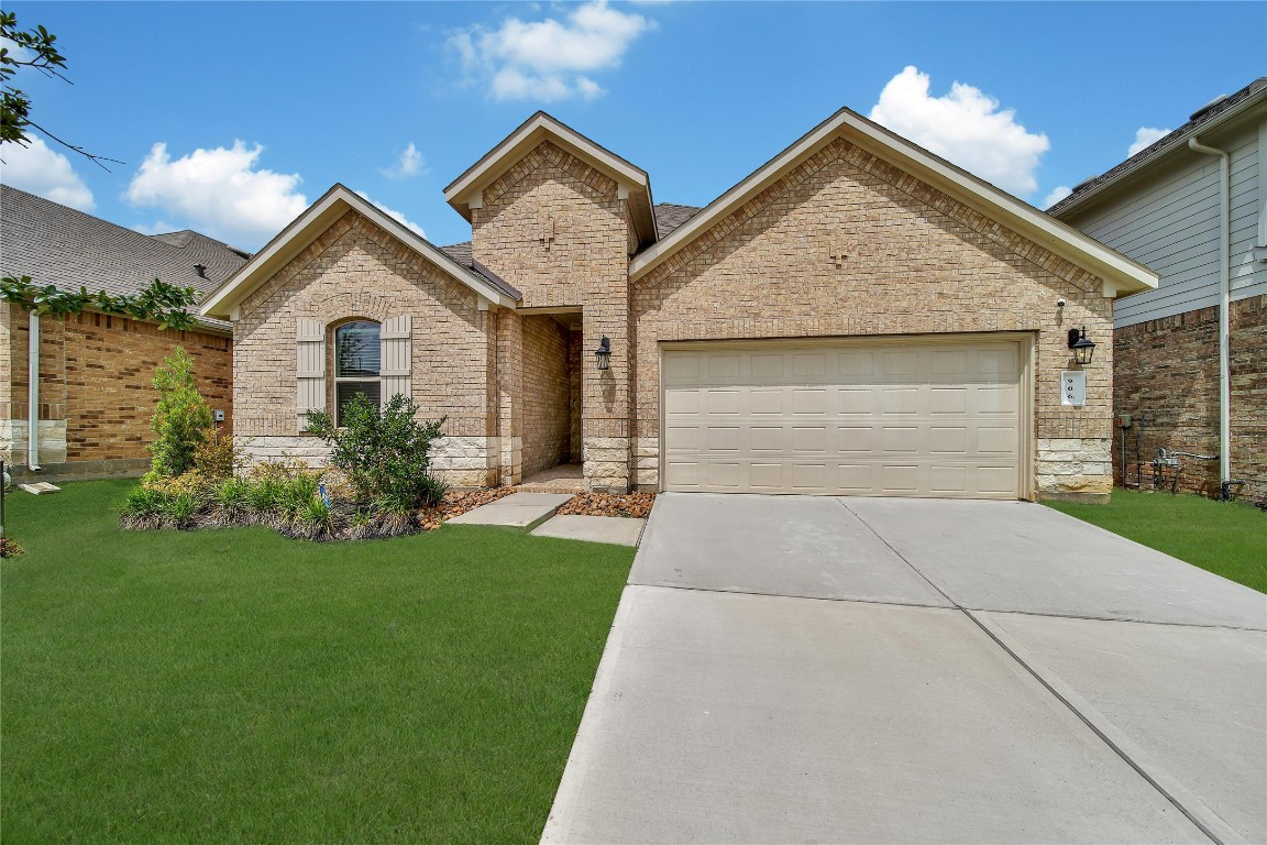906 Youth Water Road Montgomery, TX 77316 - Photo 33 of 42 a front view of a house with a yard and garage