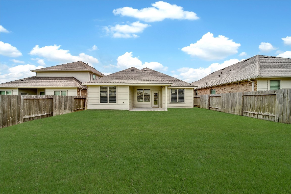 906 Youth Water Road Montgomery, TX 77316 - Photo 9 of 42 a view of a yard in front of a house with a large tree
