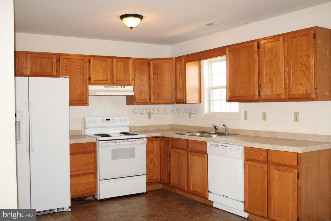 8133 Libertytown Road Berlin, MD 21811 - Photo 14 of 25 a kitchen with a sink stove and cabinets