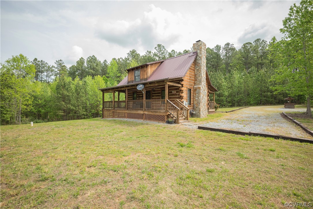 2095 Eureka Mill Road Keysville, VA 23947 - Photo 15 of 43 a backyard of a house with table and chairs