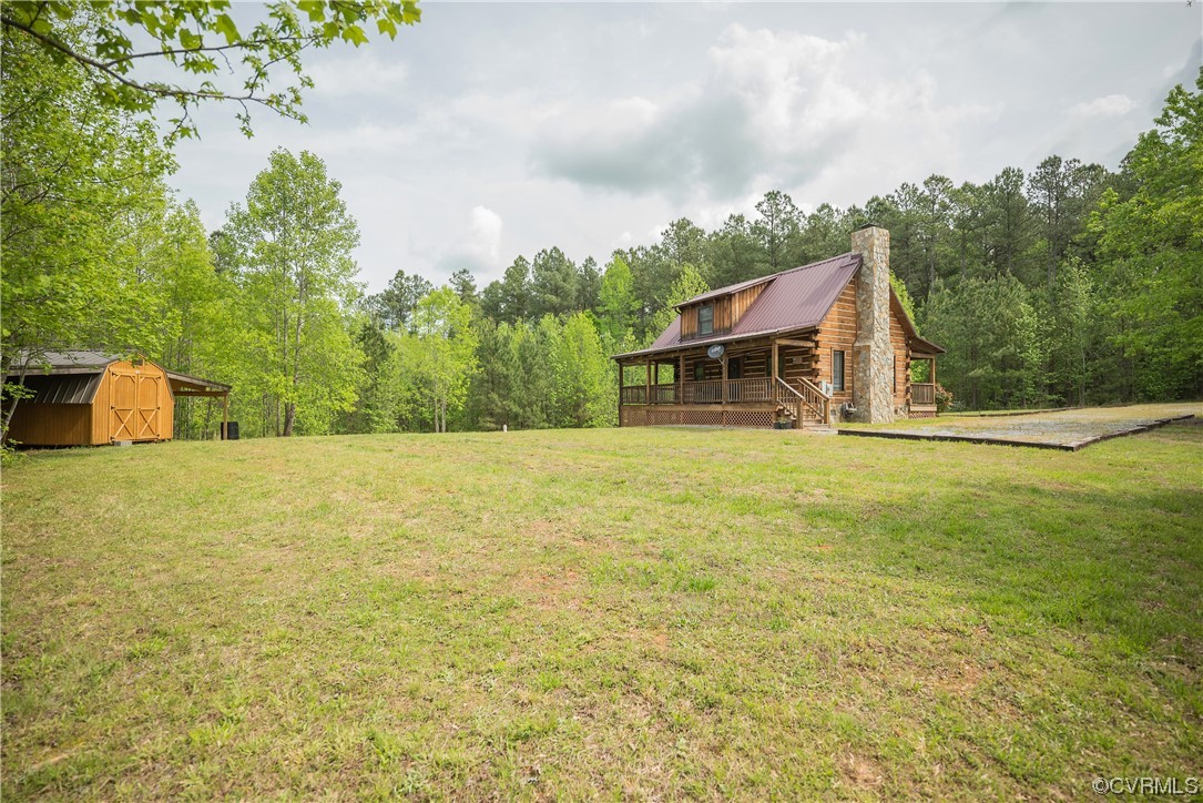 2095 Eureka Mill Road Keysville, VA 23947 - Photo 16 of 43 a house view with swimming pool and trees in the background