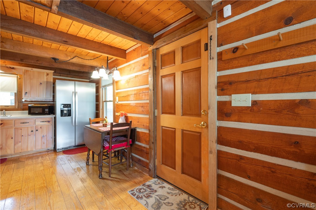 2095 Eureka Mill Road Keysville, VA 23947 - Photo 26 of 43 a living room with furniture a dining table and wooden floors