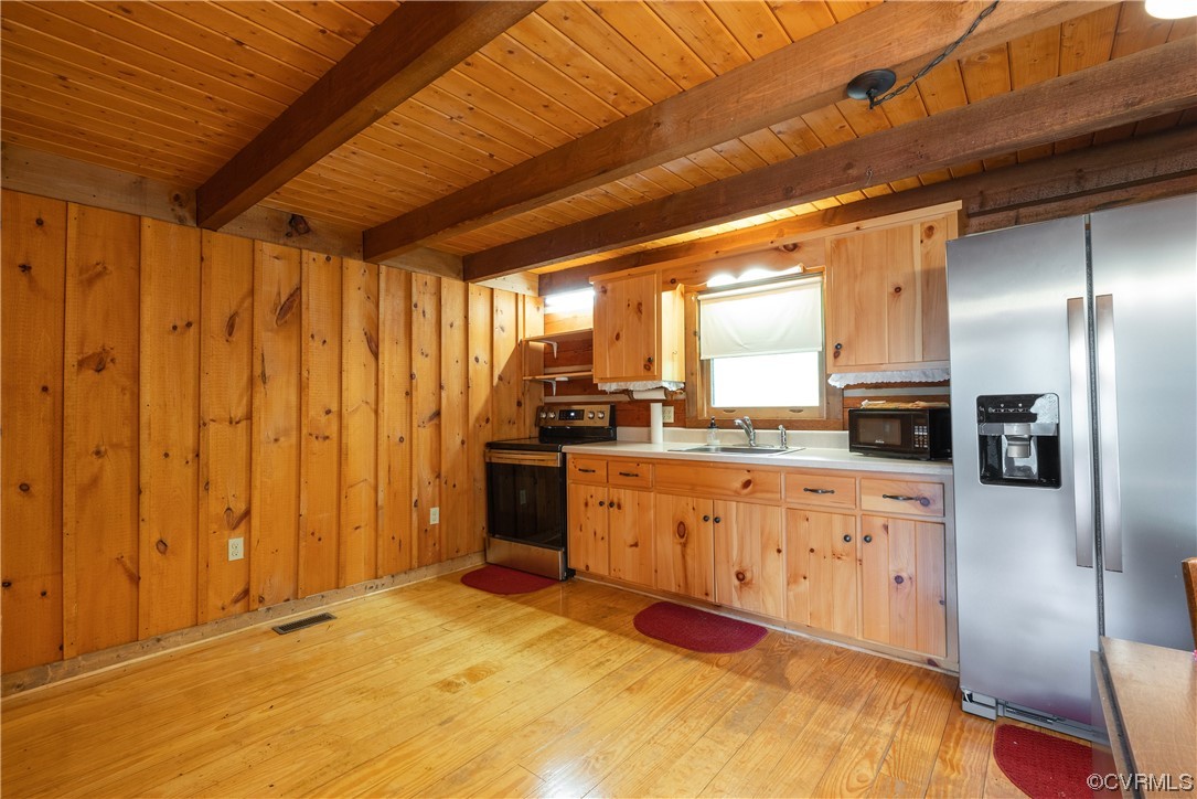 2095 Eureka Mill Road Keysville, VA 23947 - Photo 27 of 43 a large kitchen with stainless steel appliances granite countertop a refrigerator a stove and a sink with cabinets
