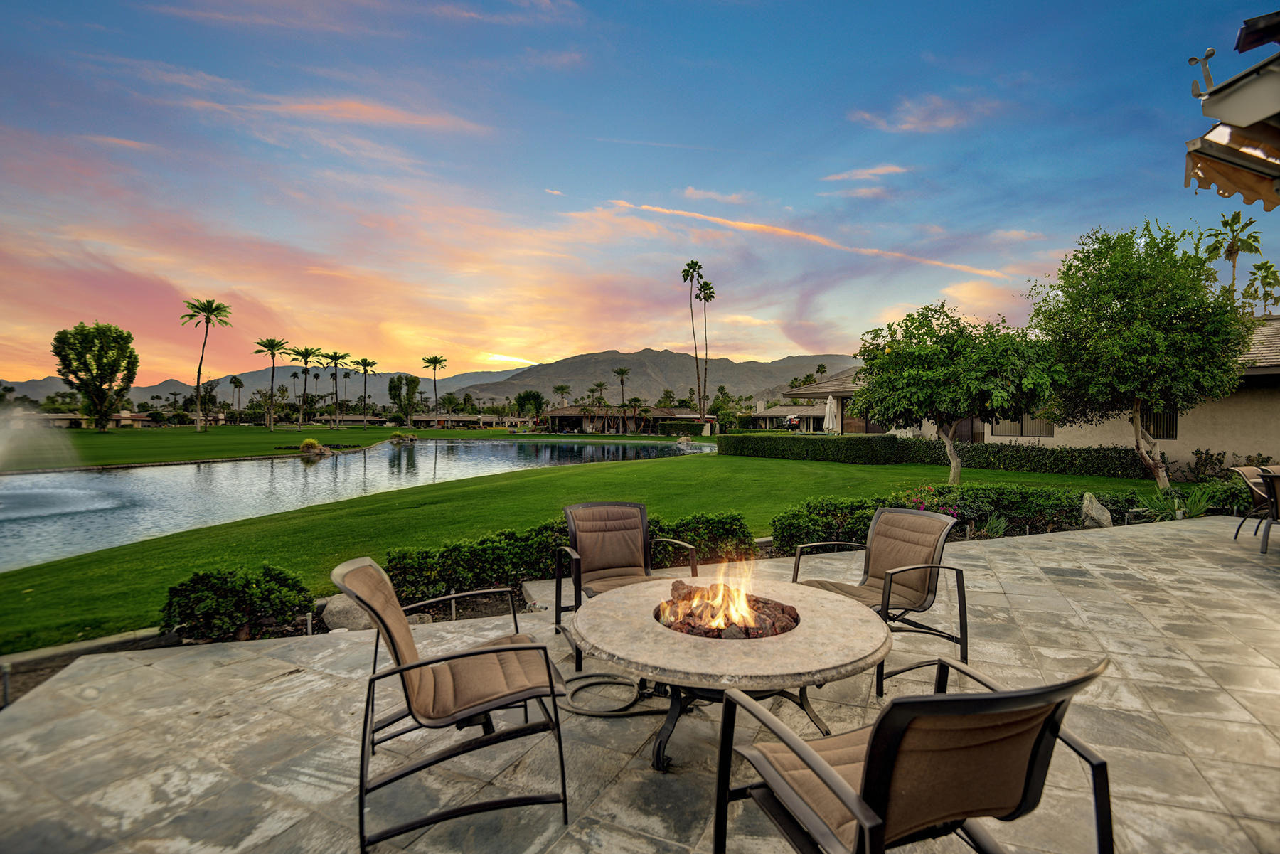 8 Rutgers Court Rancho Mirage, CA 92270 - Photo 2 of 57 a view of a lake with table and chairs under an umbrella