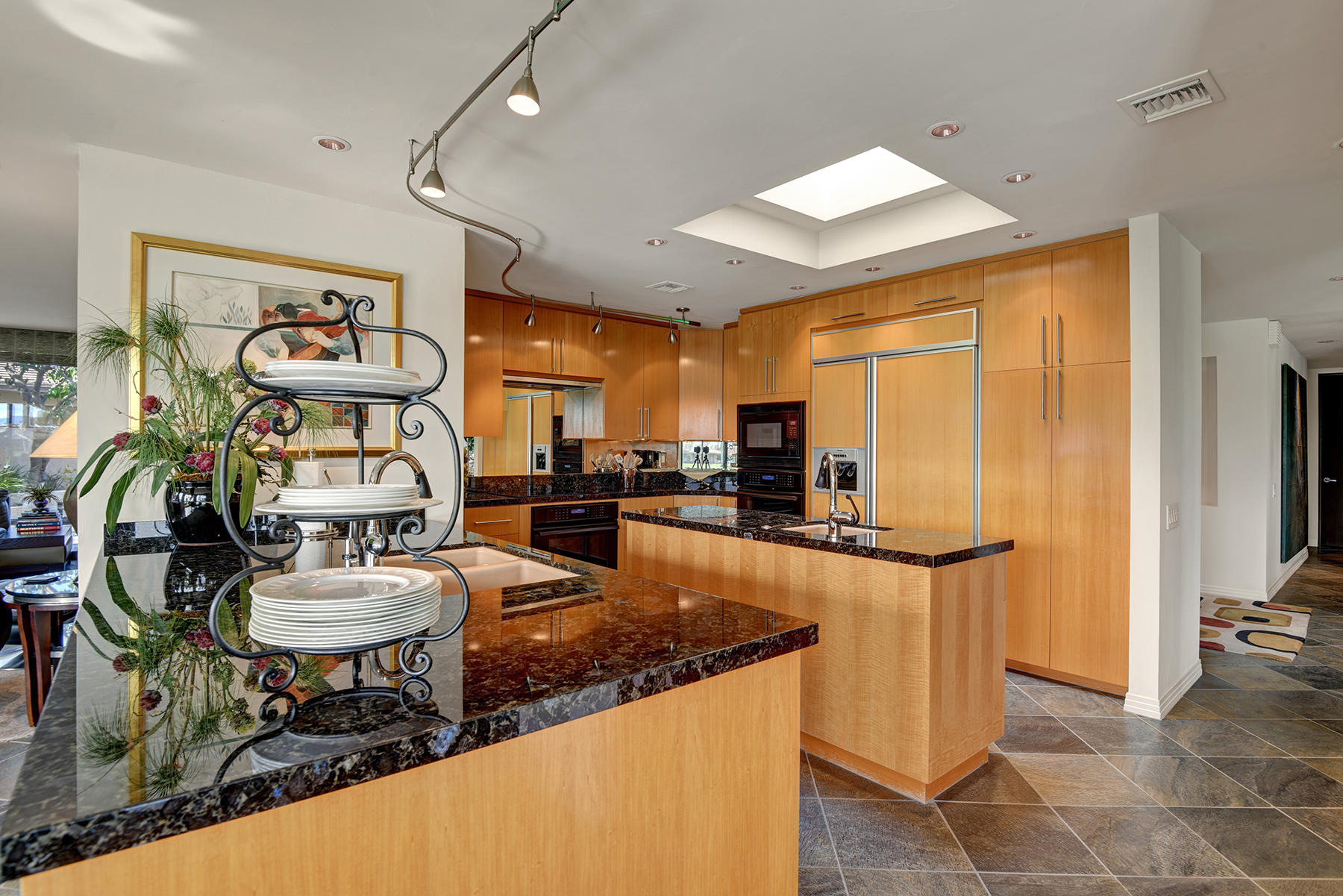 8 Rutgers Court Rancho Mirage, CA 92270 - Photo 24 of 57 a kitchen with stainless steel appliances granite countertop a sink and a refrigerator