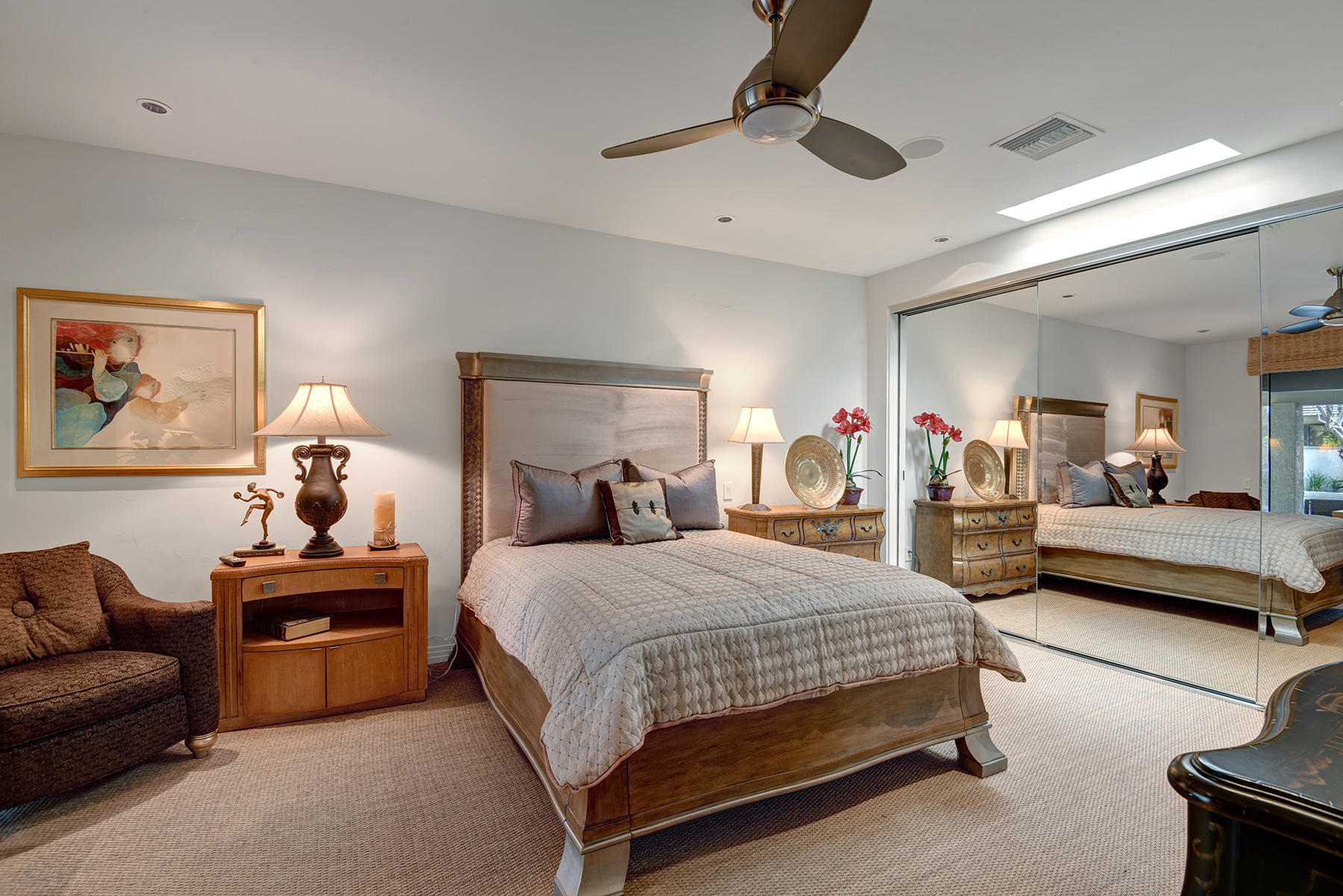 8 Rutgers Court Rancho Mirage, CA 92270 - Photo 38 of 57 a bedroom with a bed a couch and a chandelier