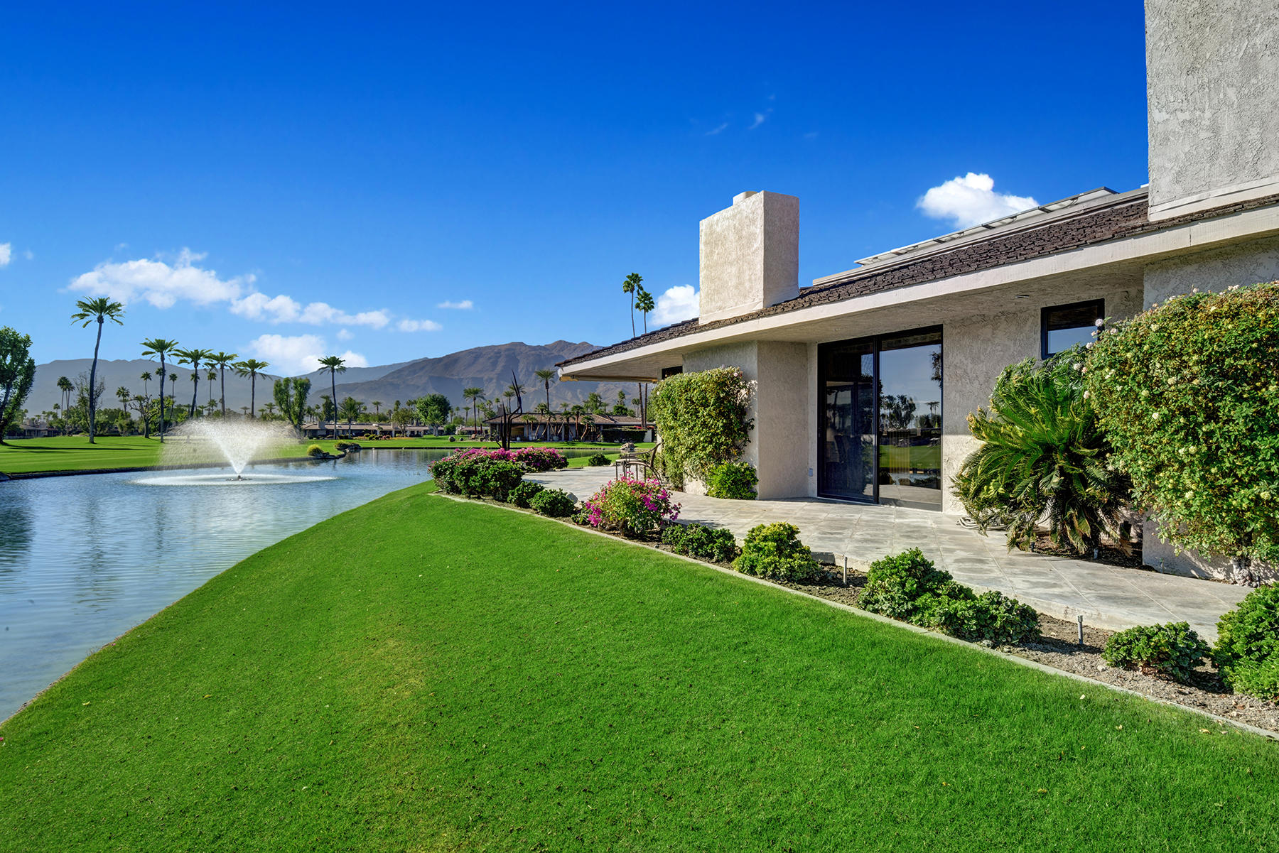 8 Rutgers Court Rancho Mirage, CA 92270 - Photo 45 of 57 a view of a patio with table and chairs potted plants and large tree