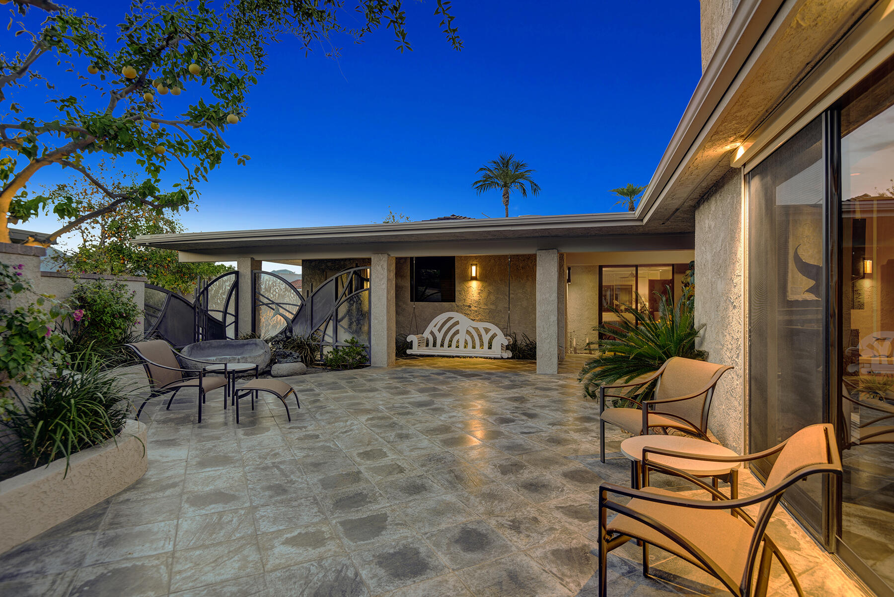 8 Rutgers Court Rancho Mirage, CA 92270 - Photo 53 of 57 a view of a patio with a table and chairs and potted plants