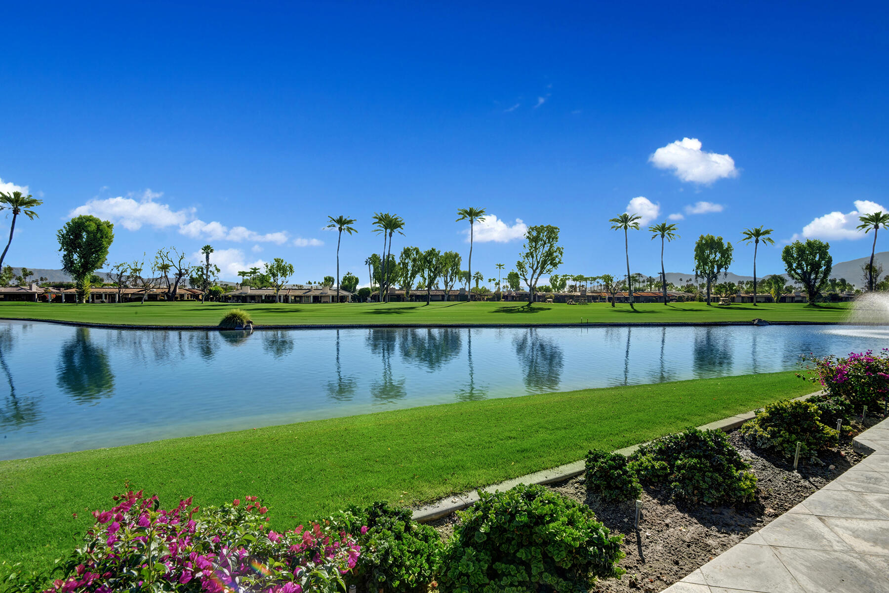 8 Rutgers Court Rancho Mirage, CA 92270 - Photo 57 of 57 a view of a lake with a house in the background