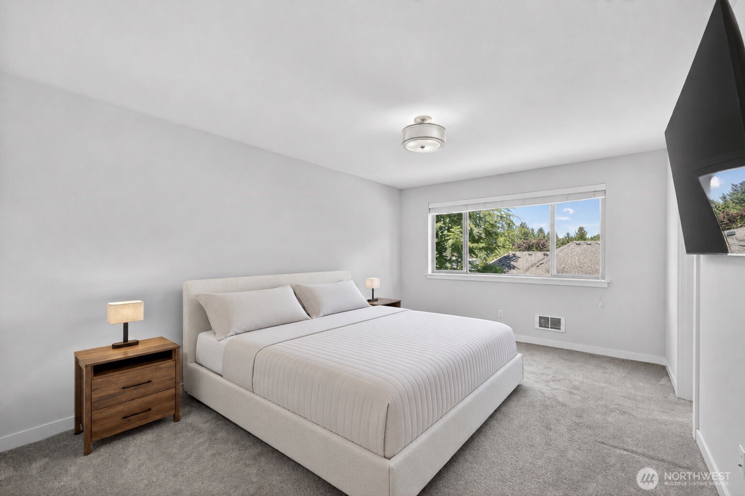 629 Bing Road, Unit B Lynnwood, WA 98036 - Photo 10 of 27 a bedroom with a large bed and a flat tv screen on a dresser