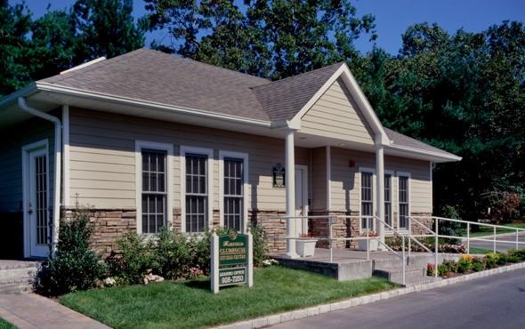 a view of a house with yard and plants