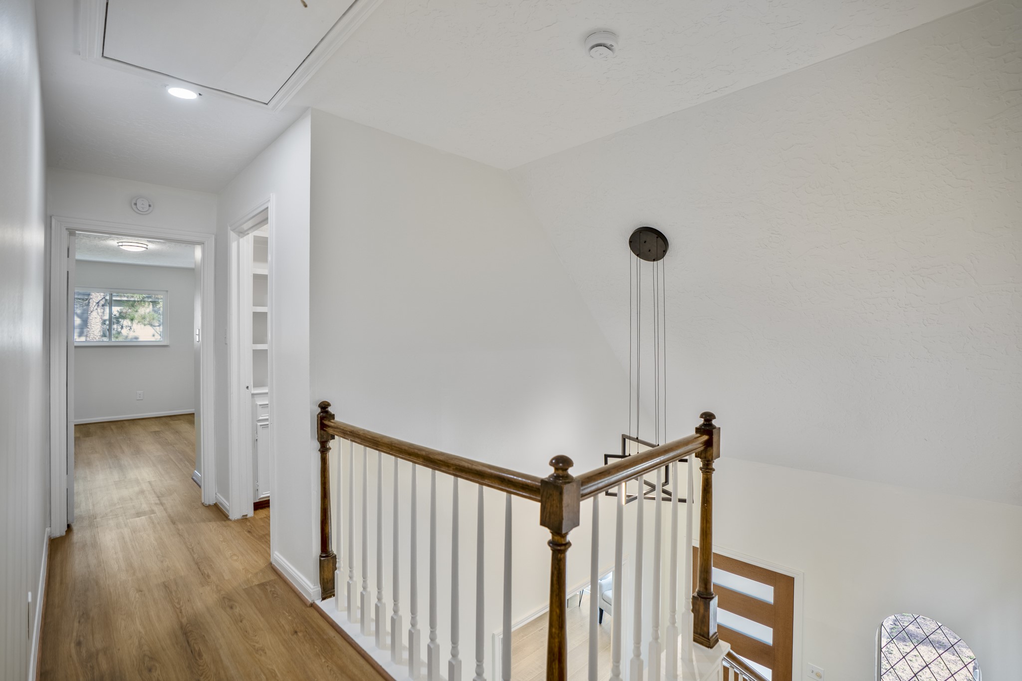 6303 Larkmount Drive Spring, TX 77389 - Photo 27 of 50 Heading upstairs, the updated oak staircase leads to a bright landing where the fresh finishes continue with luxury vinyl flooring and updated paint. From here, the second floor branches toward three bedrooms, a full bath, and the flexible bonus room, giving the upstairs its own comfortable sense of space.