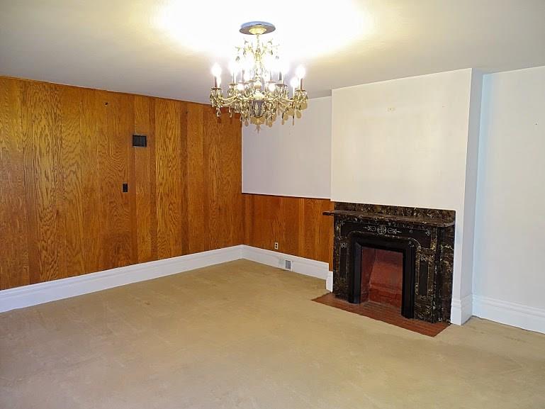Decorative fireplace and chandelier in the living room.