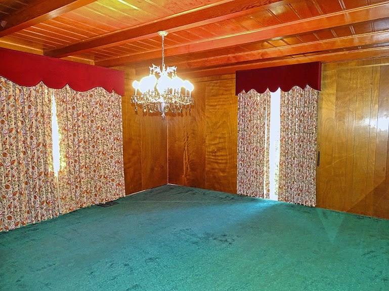 The enormous dining room has 2 extra large windows. Can you imagine the people you could fit around a table in a room this size?