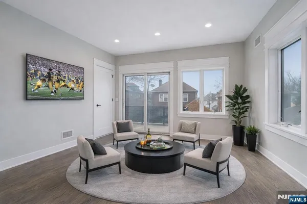 a living room with furniture and a large window