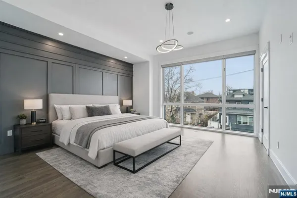 a spacious bedroom with a bed and a large window